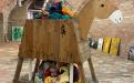 Trojen donkey, mad from found material, carries discarded cloth, sustainability, saving resources, memorial to society